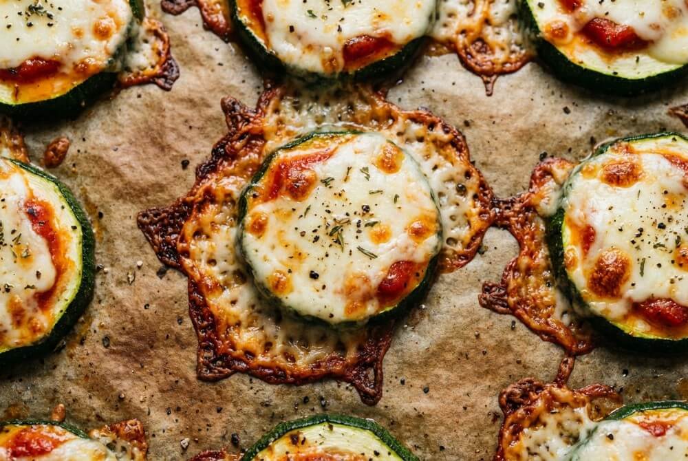 Zapiekane krążki cukinii z sosem pomidorowym i serem mozzarella.